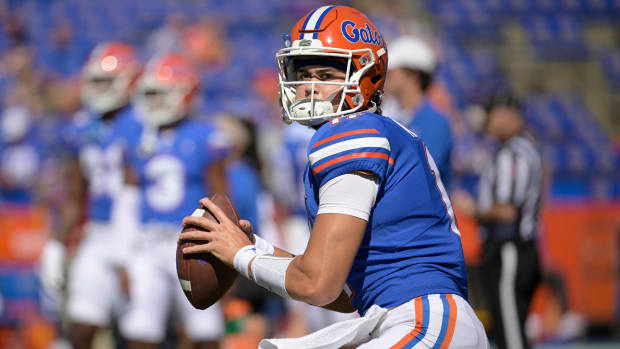 Former Florida quarterback Jalen Kitna prepares to throw a pass while warming up before a game.